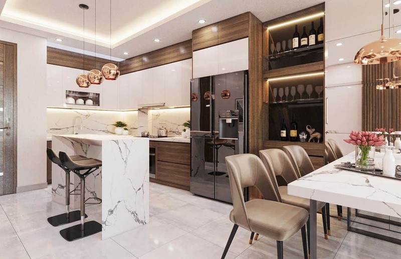 Không gian phòng bếp sang trọng được tạo nên từ hệ thống tủ bếp gỗ cao cấp, mặt bàn đảo, bàn ăn được ốp đá cẩm thạch màu trắng xa hoa
